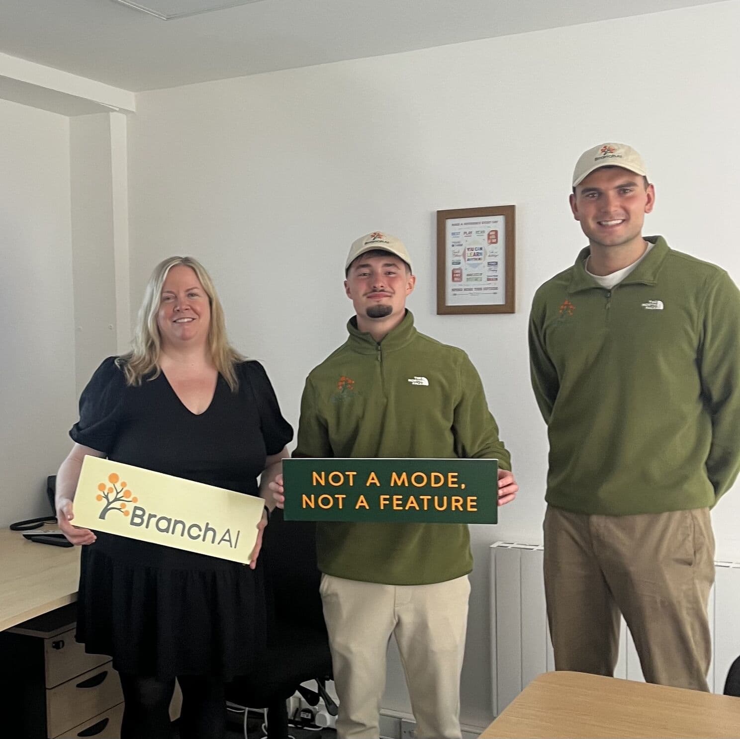 Rosie Bissett of Dyslexia Ireland with BranchAI co-founders Jonathan Lane and Luke Carroll, holding a BranchAI sign and a sign reading 'Not a mode, not a feature'.